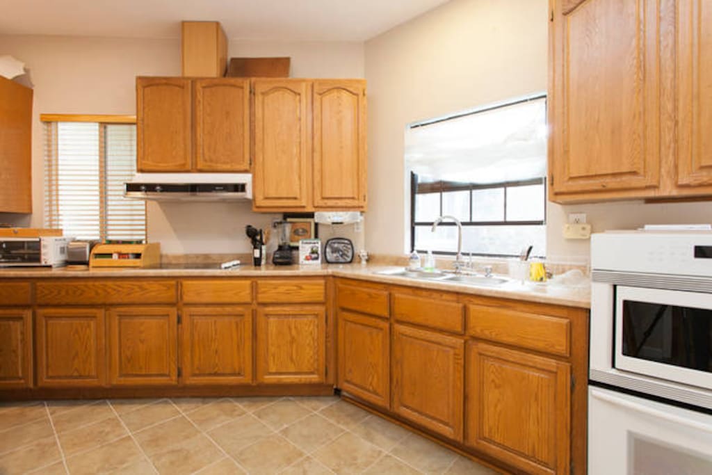 Full kitchen with microwave, oven, sink and stove