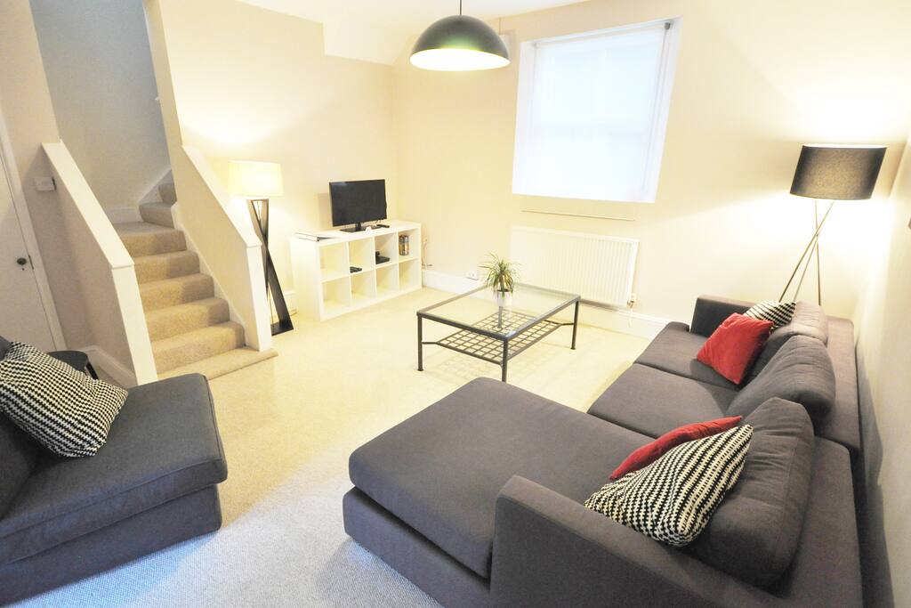 living room showing stairs to 1st floor