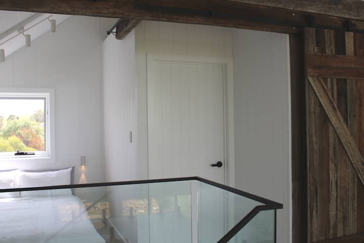 Mezzanine level double bed with new bedding and matress topper, close off with with privacy curtains 