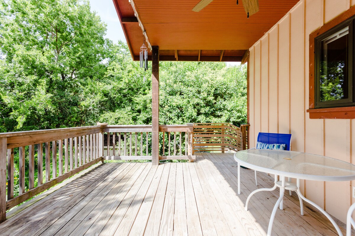 Secluded tree house apartment with high ceilings.