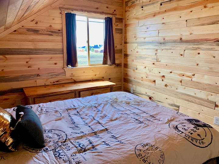 Bedroom #1 Upstairs with a queen-sized log bed.