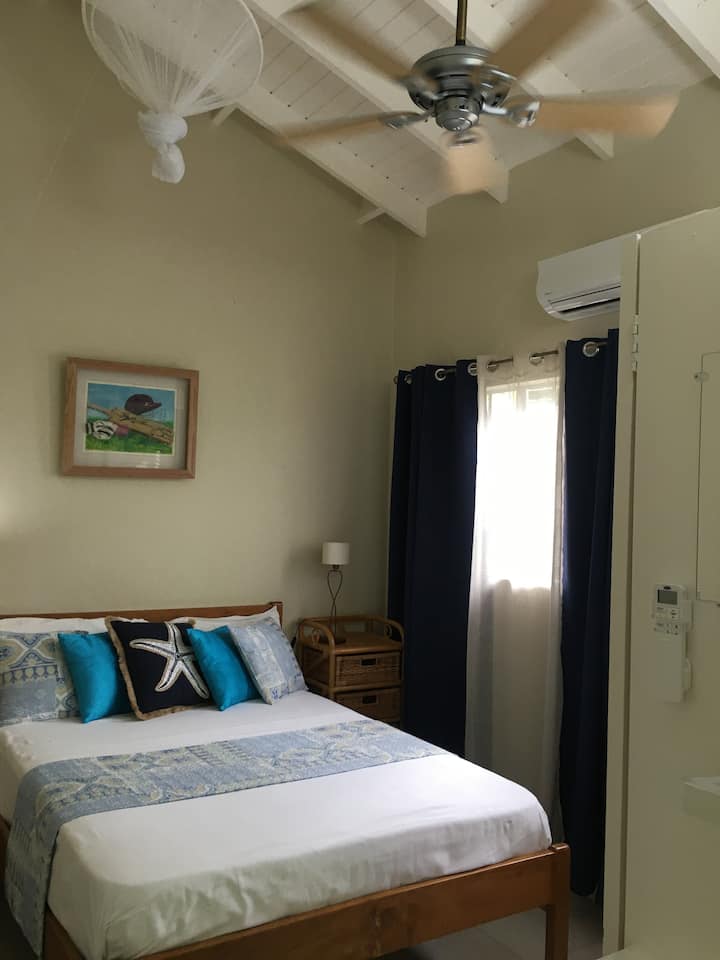 South bedroom  - A/c, fan and  comfortable bed with new mattress, black out curtains, ample cupboard space, decorated with local art.