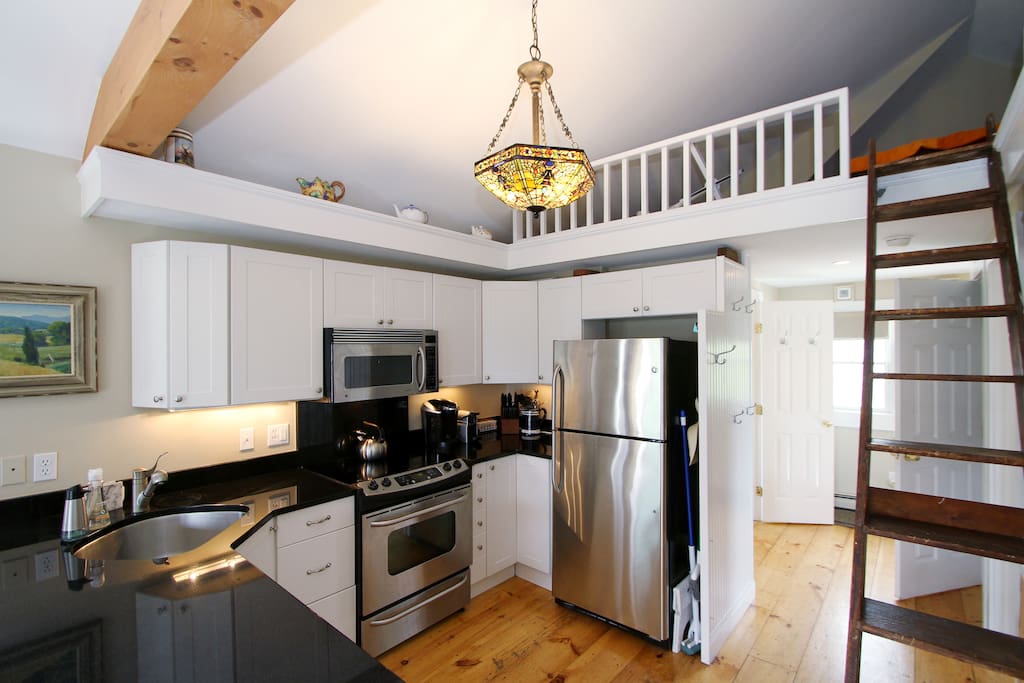 The kitchen has a full suite of stainless steel appliances.