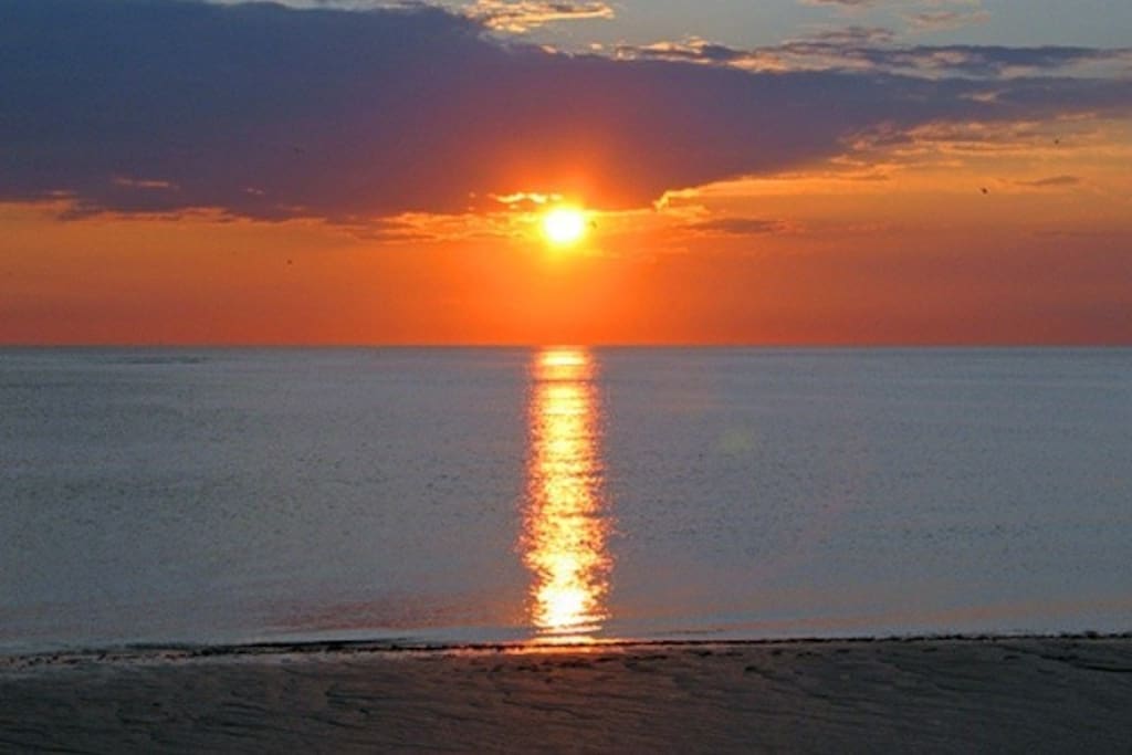 Sitting on the sand watching the evening sunset. It's breathtaking!