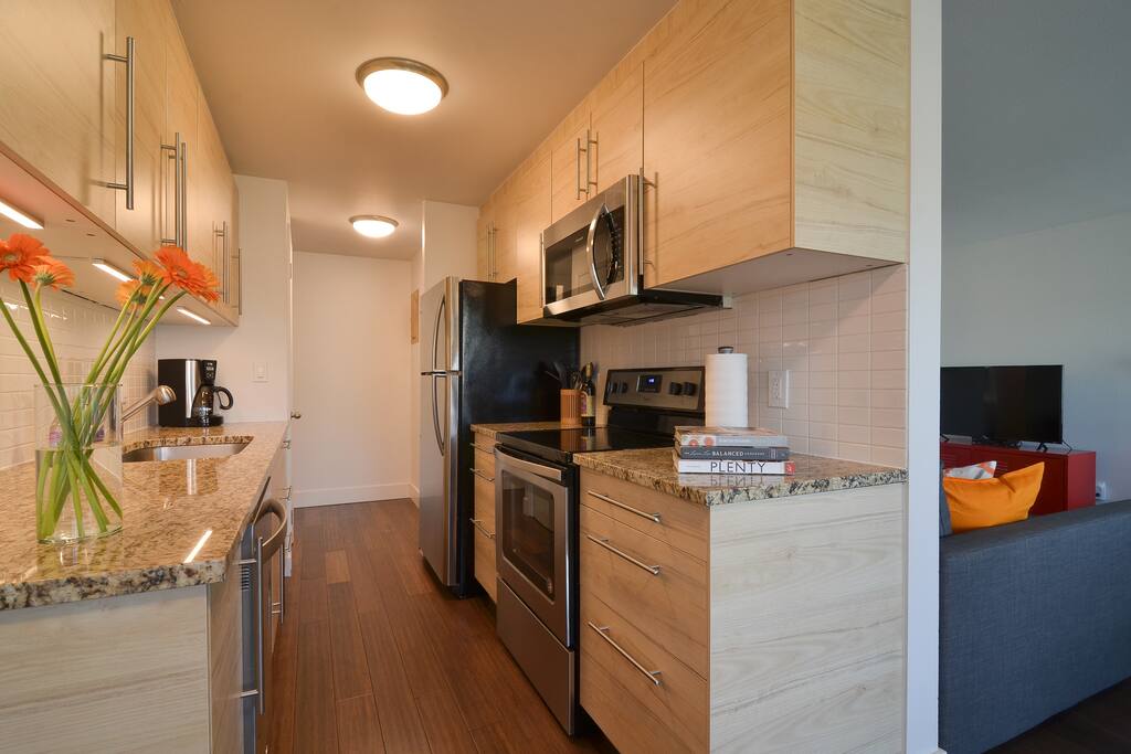 Kitchen with brand new stainless steel appliances.