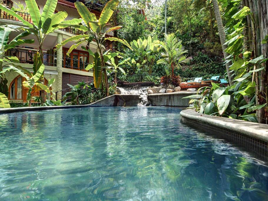 Huge lagoon pool with waterfalls surrounded by the rain forest