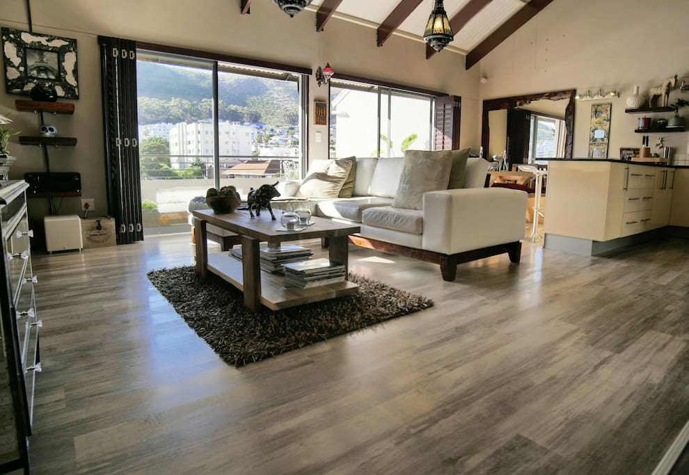 Large open plan lounge, dining and kitchen area with a full view of the mountain range.