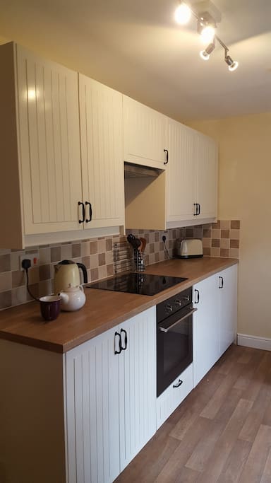 The newly fitted kitchen is well-equipped - there's a ceramic hob, oven, fridge with freezer compartment and dishwasher