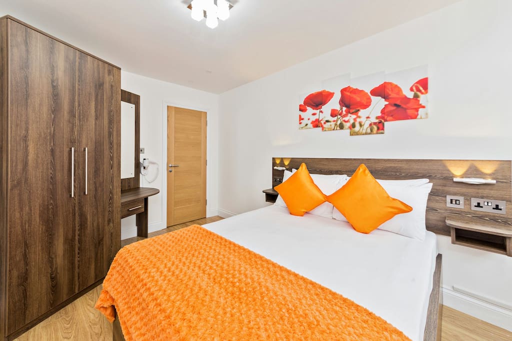 The comfortable King size bed is made up with hotel style linen, and has charging points and reading lights at the bed side