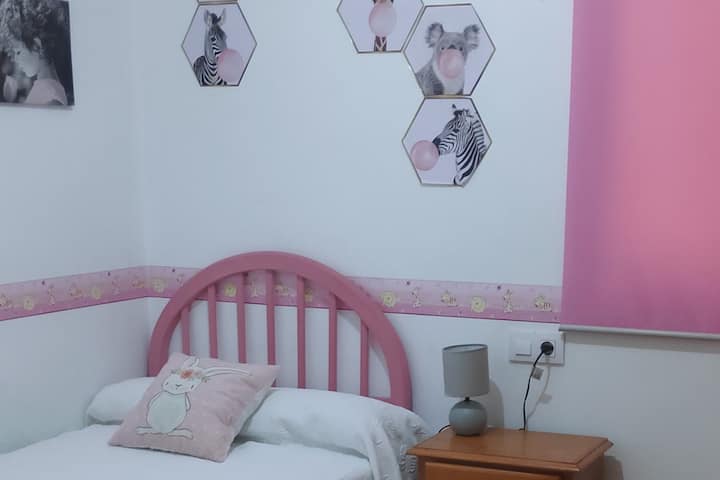 Childrens room with 90cm bed. A closet and a clothing rack.