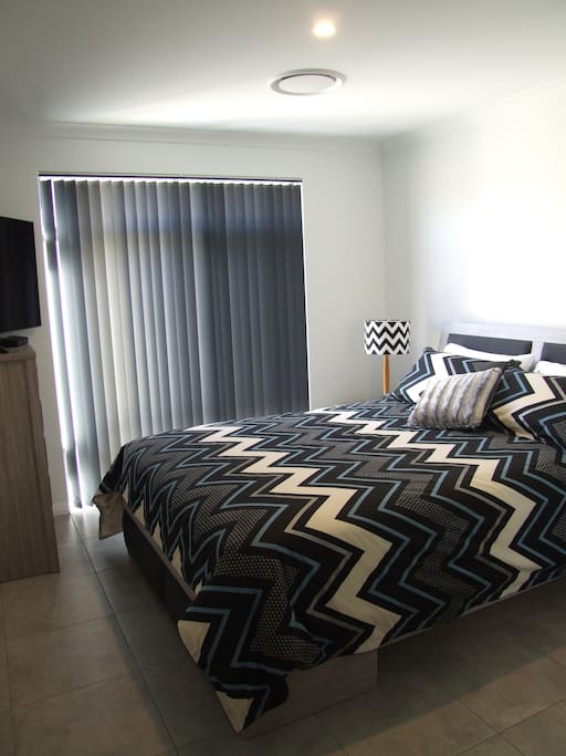 Queen bedroom with TV