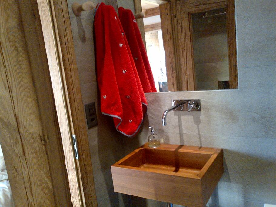 En-suite bathroom off the master bedroom, the bath has views of the mountain. There are two other shower rooms, also with toilets.