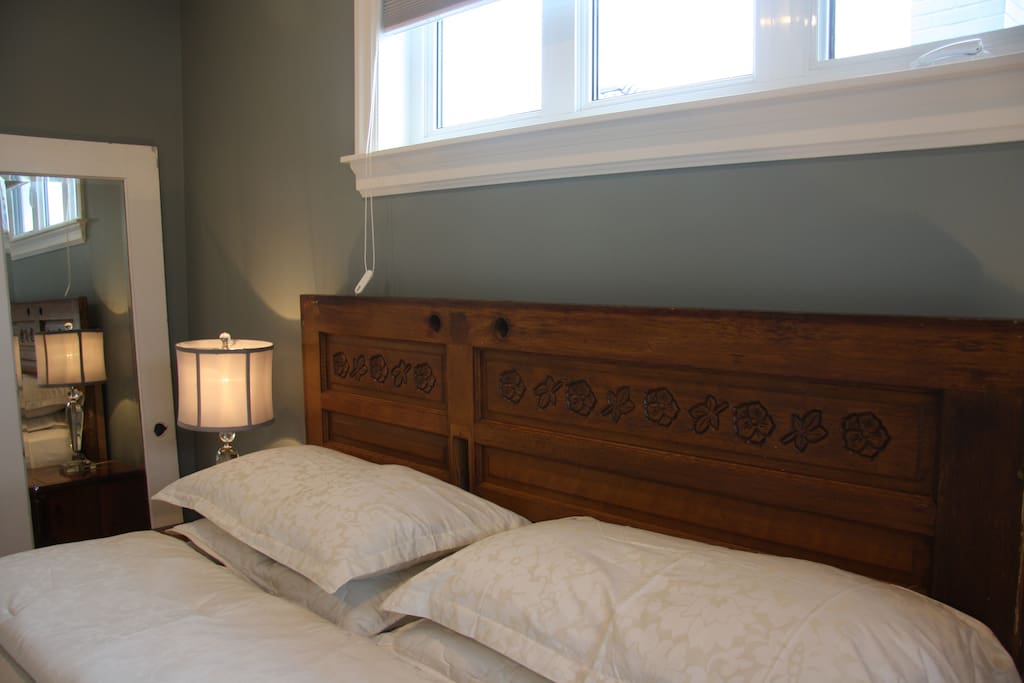 The old house's front door and the entrance closet doors now have a second life as the headboard and mirror.