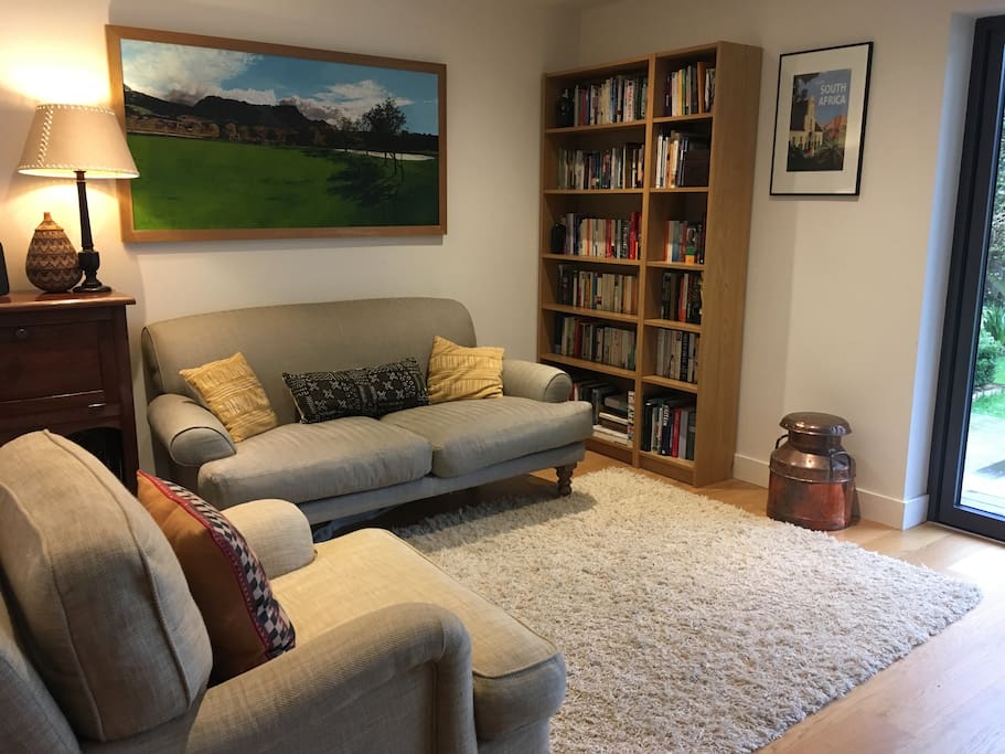 The open plan living space with folding doors onto deck and garden. There's a toy cupboard here for the under-5s with games and cars. And a Sonos Play:5 for sound.