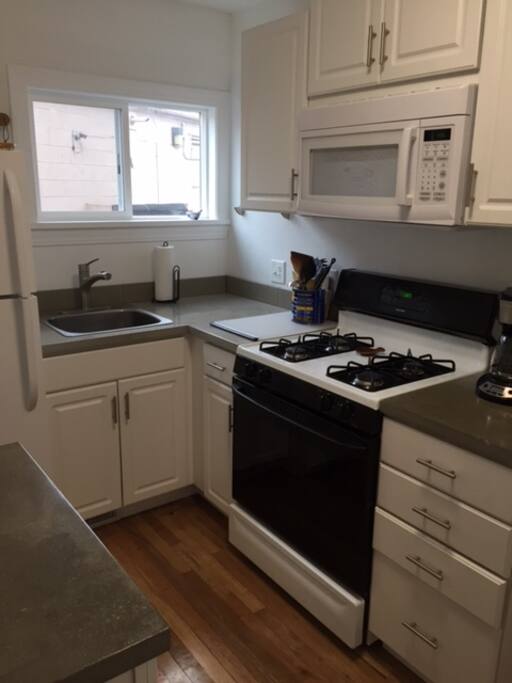 Kitchen has full refrigerator, gas range and is complete with dishes, utensils, pans, microwave, toaster and blender.