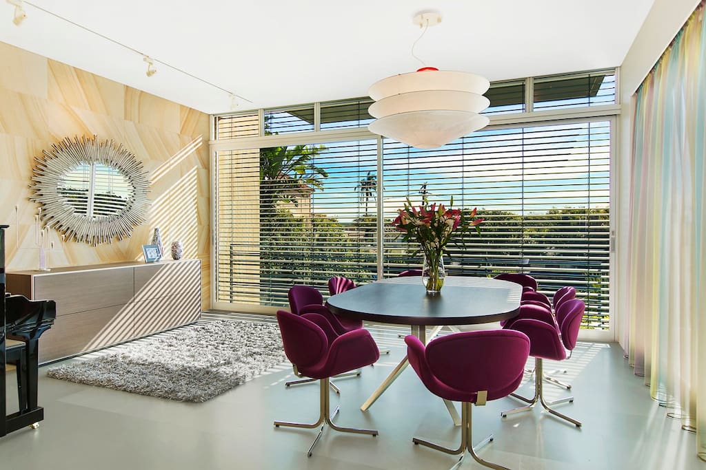 Formal dining room with glimpses to Sydney harbour.