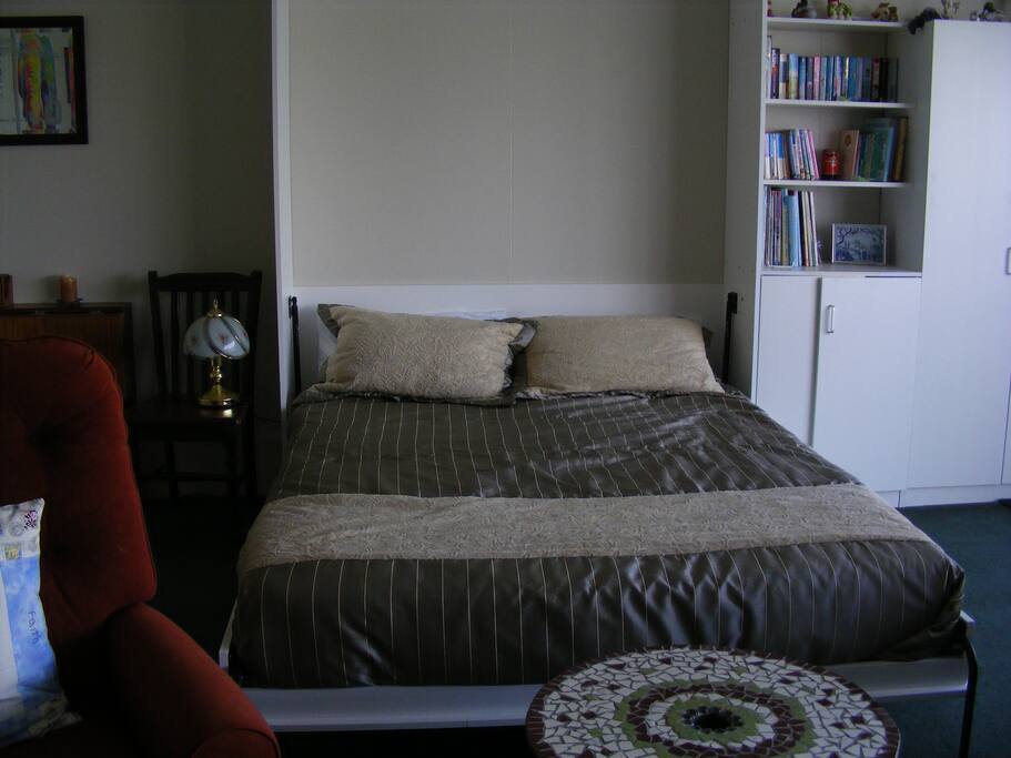 Queen size murphy bed tucks away during day if required