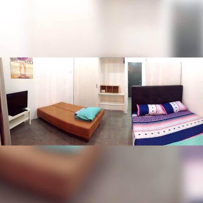 Left: sofa bed after being turned down. Unit sleeps 3 comfortably. Behind: additional storage space in built-in cabinet.