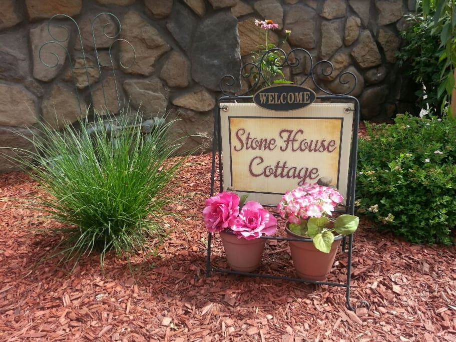 Welcome sign in the landscape states that this is the Stone House