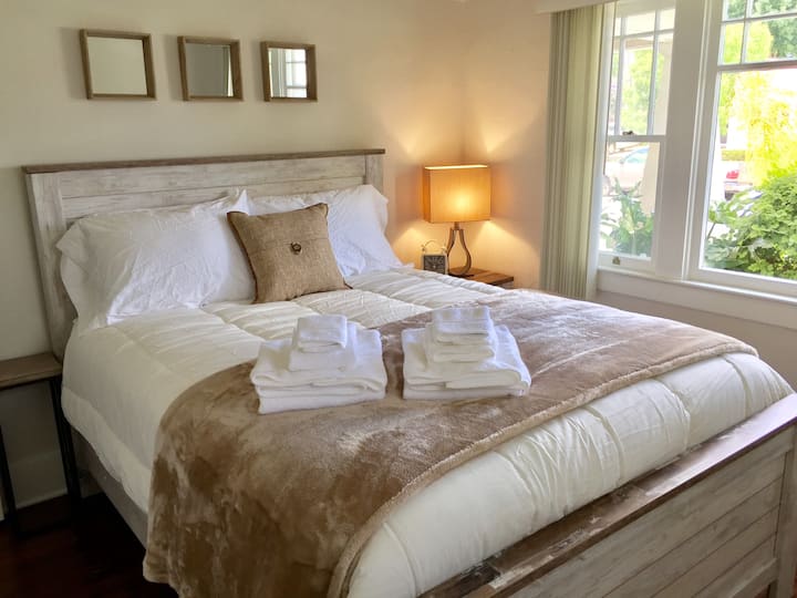 Another bedroom:  fully upgraded with high-end Ashley Anniversary Plush queen mattress.  Fresh linens and plenty of pillows. USB charging stations on both nightstands.  Lots of natural light and brand new furnishings. 