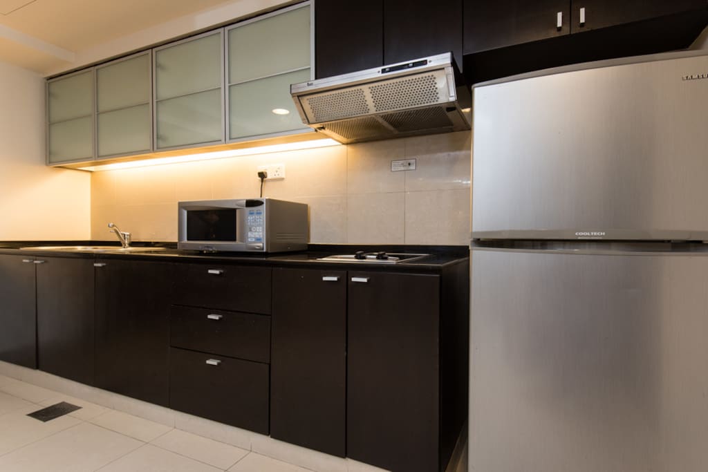 Fridge and kitchen with cooking facilities