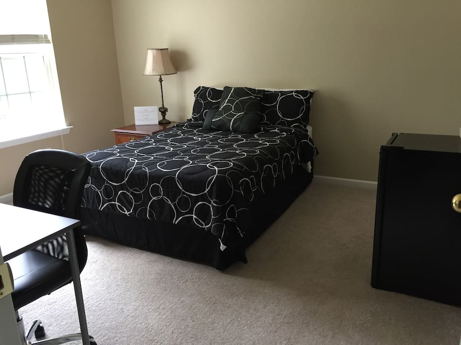 Bedroom complete with full size bed, nightstand, dresser, computer desk, TV/DVD player, closet, and mini fridge.