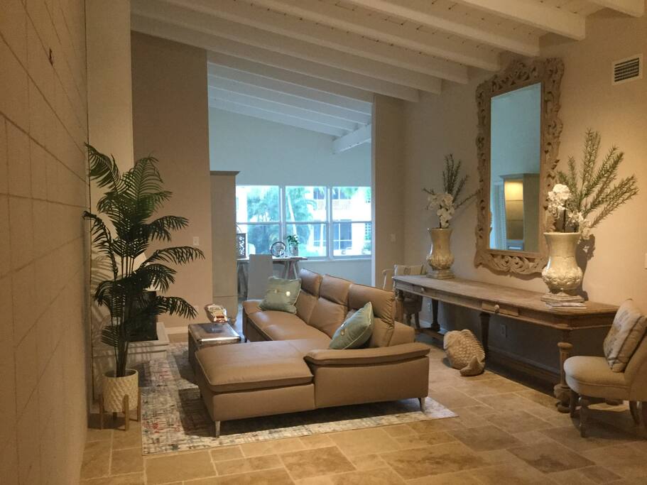 Living area with travertine floors and a Murphy bed