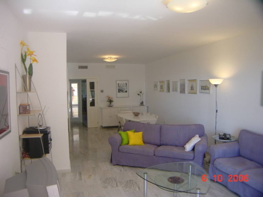 The lounge seen from the dors to the terrace. Dining area leads to kitchen and utility room.