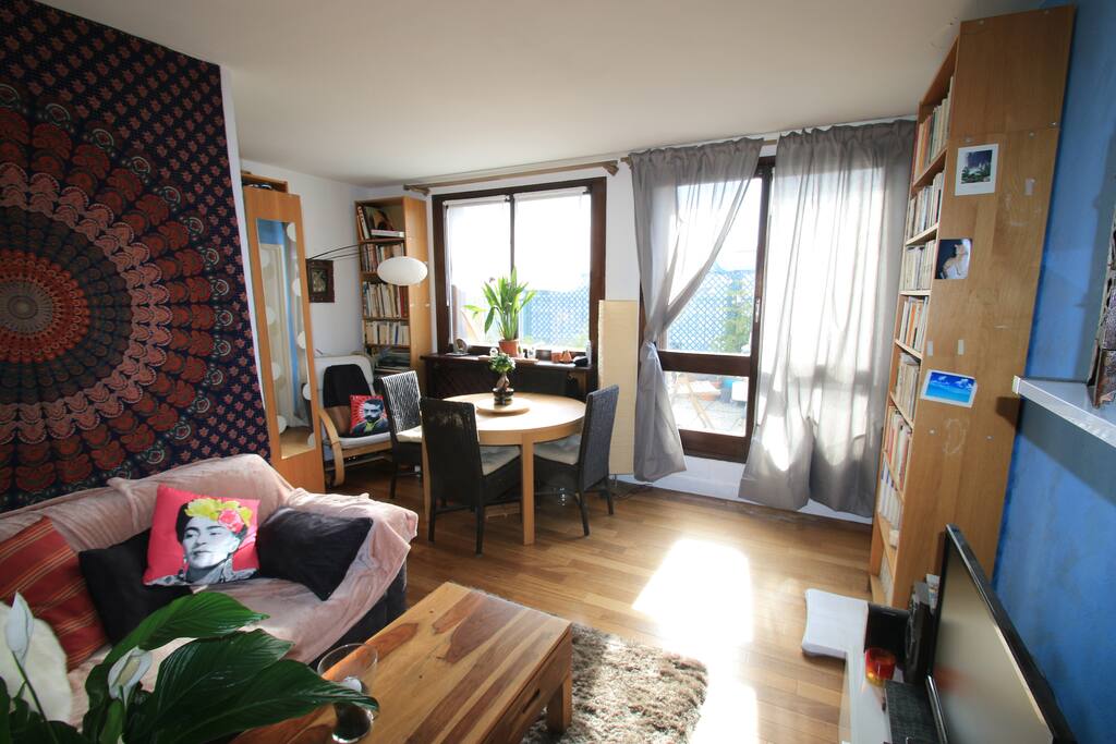 The living room, with the library corner and the terrace outside.