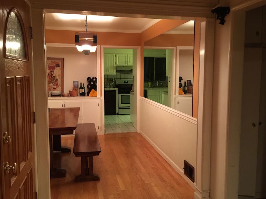 View from the living room into the formal dining room and the kitchen is beyond the dining room.