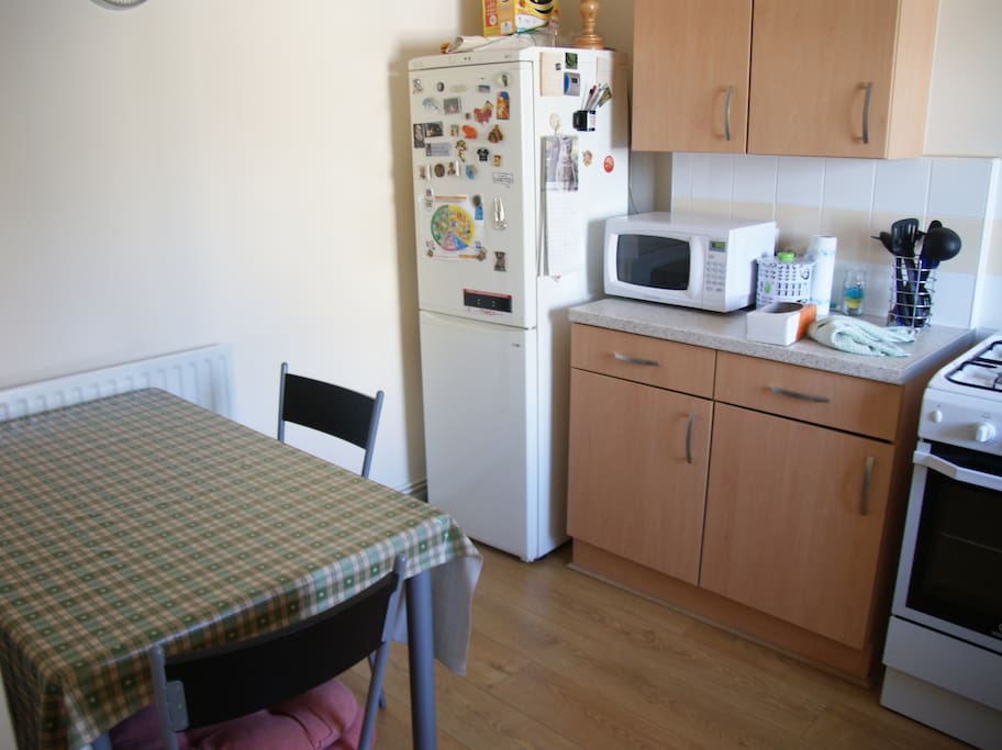 Fridge, microwave, table and chairs.