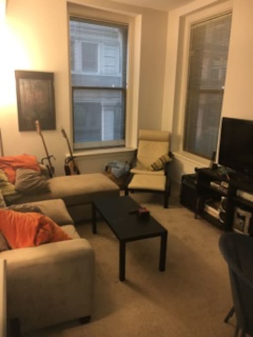 Comfortable, large couch and tall windows in the living room