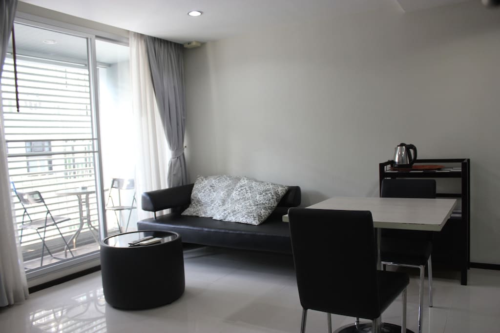 Living and dining area. There is a small terrace outside.