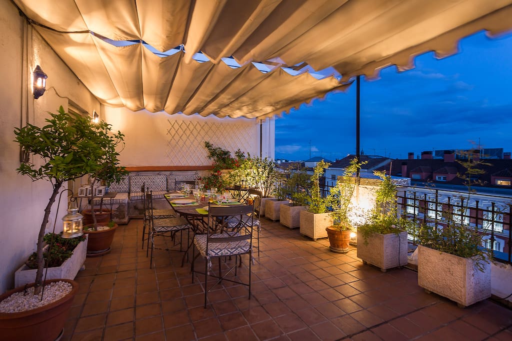 Well lit terrace at night with great views of Madrid lighting.