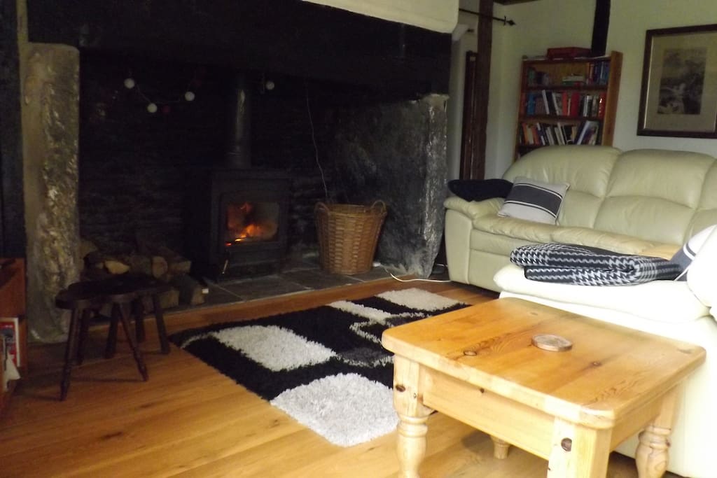 Large fireplace with wood-burner in living room