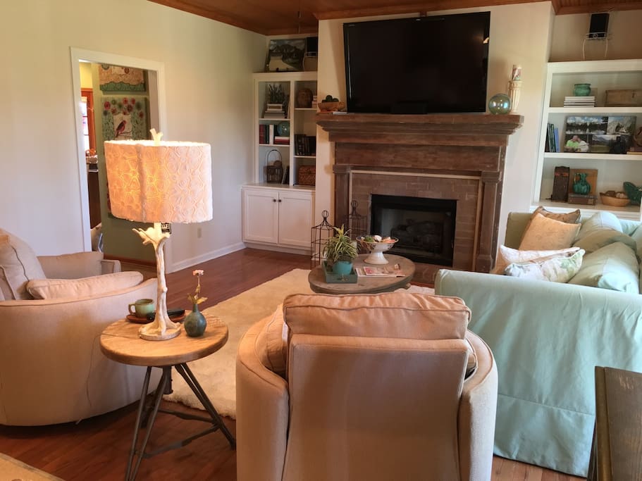 63 inch surround sound tv/sonos system/direct tv/100 year old mantle fireplace. Two cool recliners for chilling.