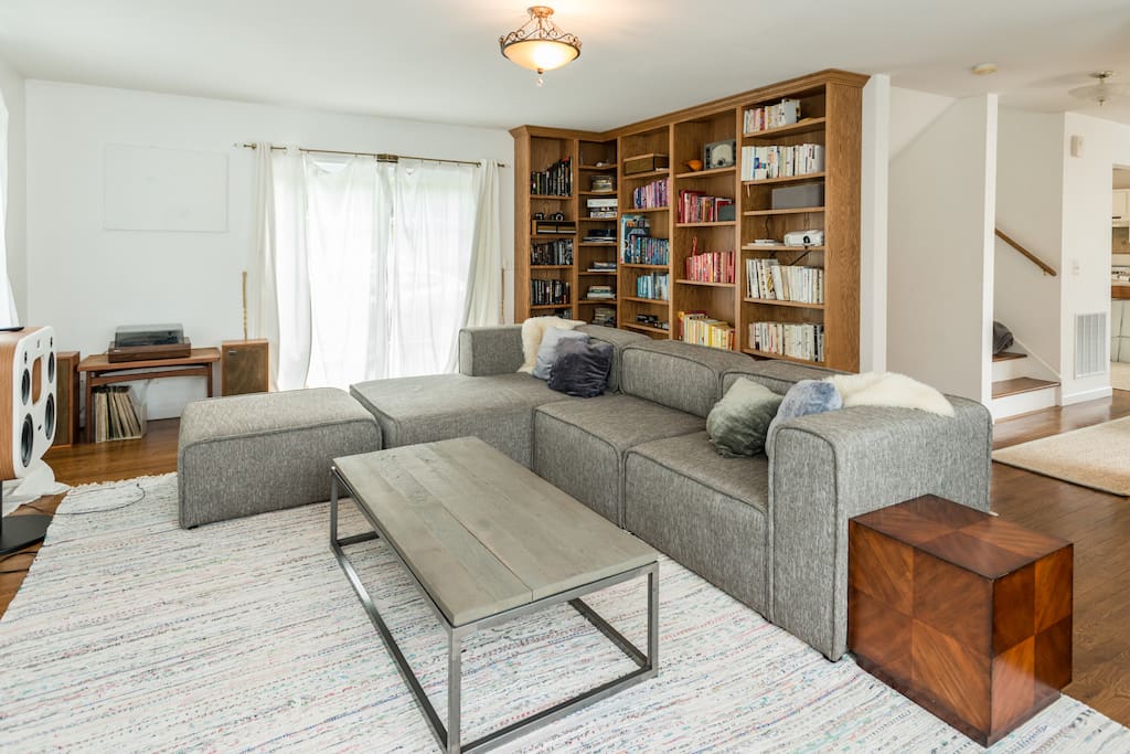 The living room has a HUGE sofa and built-in bookcase—home to the movie projector and tons of reading.
