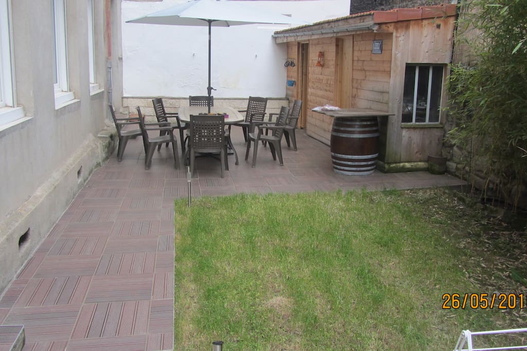 Terrasse avec tables / chaises + plancha et rangements dans les cabanons