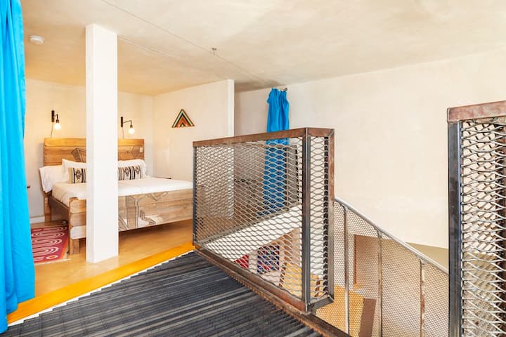 The Crow's Nest, is our cozy third floor sleeping loft with queen bed. It has built in curtains that can be closed for privacy and an adjacent meditation nook. It is up a spiral staircase, so adults only in this bedroom.