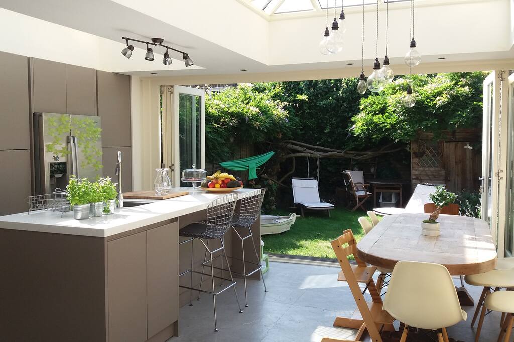 The kitchen opens on a mature garden where a 100 years old wisteria decorates the fences with incredible purple blooms. The table sits 8-10 people easily.