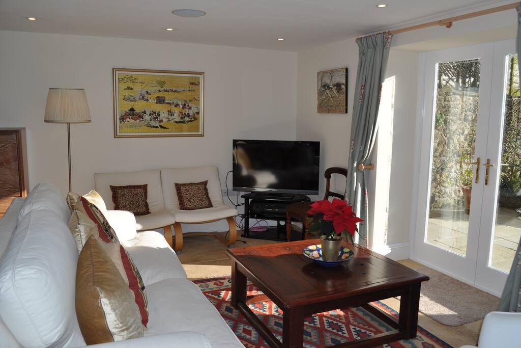 Open-plan sitting room with access to patio