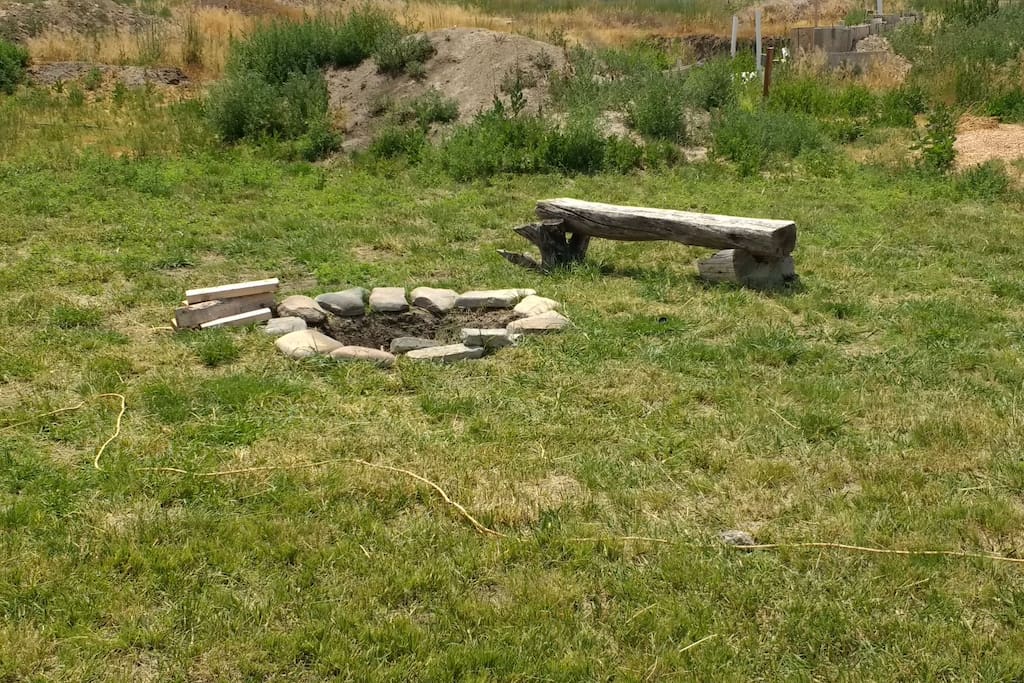 Fire pit. Two bundles of wood are provided.