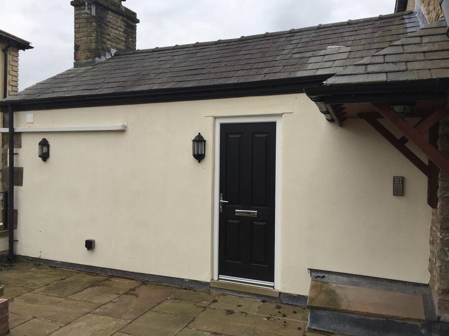Entrance to 1st floor apartment via steps from car park at the rear