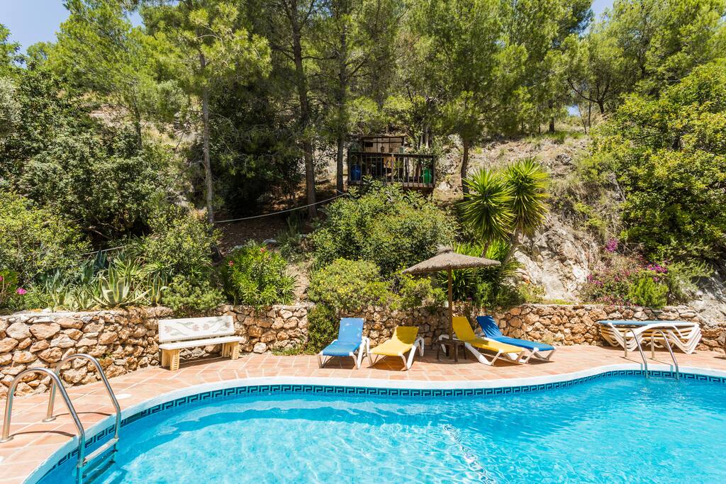 Tree house pool bar overlooks pool and BBQ AL fresco eating area