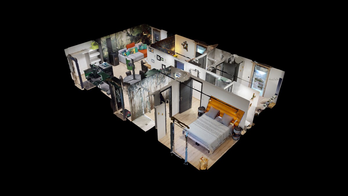 An aerial view of the spacious 90m2 apartment reveals a modern layout. Three bedrooms are visible, along with an open living area featuring integrated kitchen appliances. Contemporary design elements, including unique wall art and varied textures, contribute to the overall aesthetic.