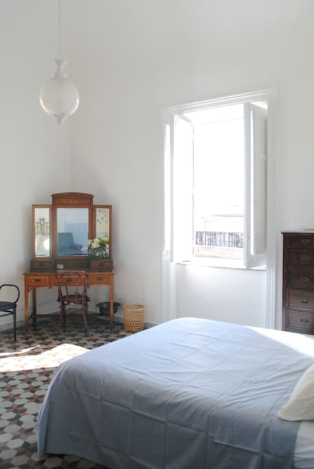 Very large and bright double room with window and a balcony - it faces the back of Teatro Massimo