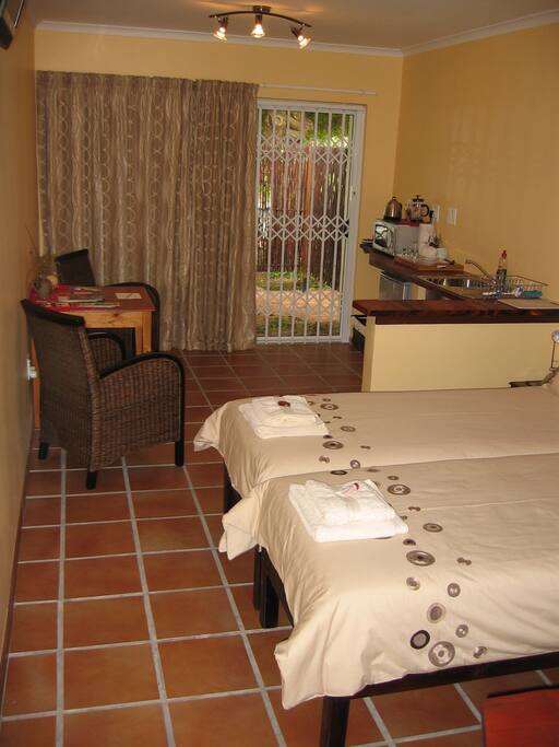 Each of the two rooms has extra long twin beds which can be made up as one queen-size bed and are equipped with basic self-catering facilities and a workspace.