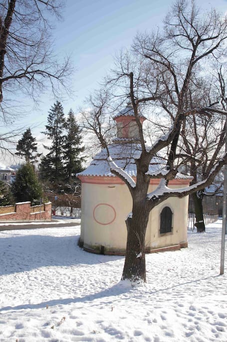 The small chapel on the opposite side of the street.