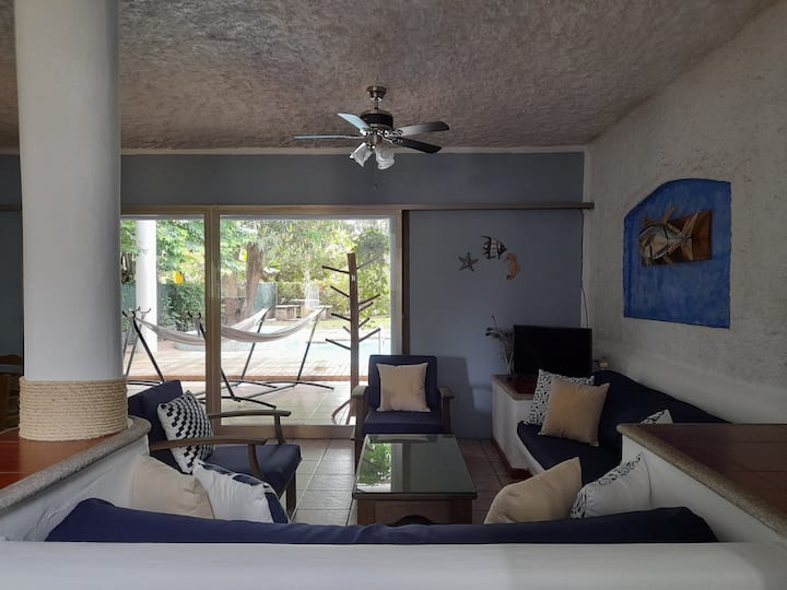 Spacious and comfortable living/dining area with 24,000 btu air conditioning, flat screen with cable and beautiful Ecomadera furniture. The view towards the pool creates a very relaxing atmosphere.