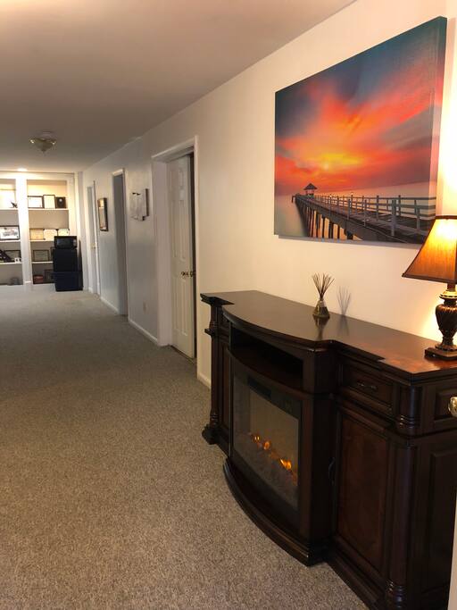 Lower Level Studio Apartment. Electric fire place and canvas art work are displayed. Total Privacy.